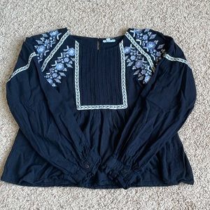Small black blouse by Rebellion with embroidered flowers and designs.